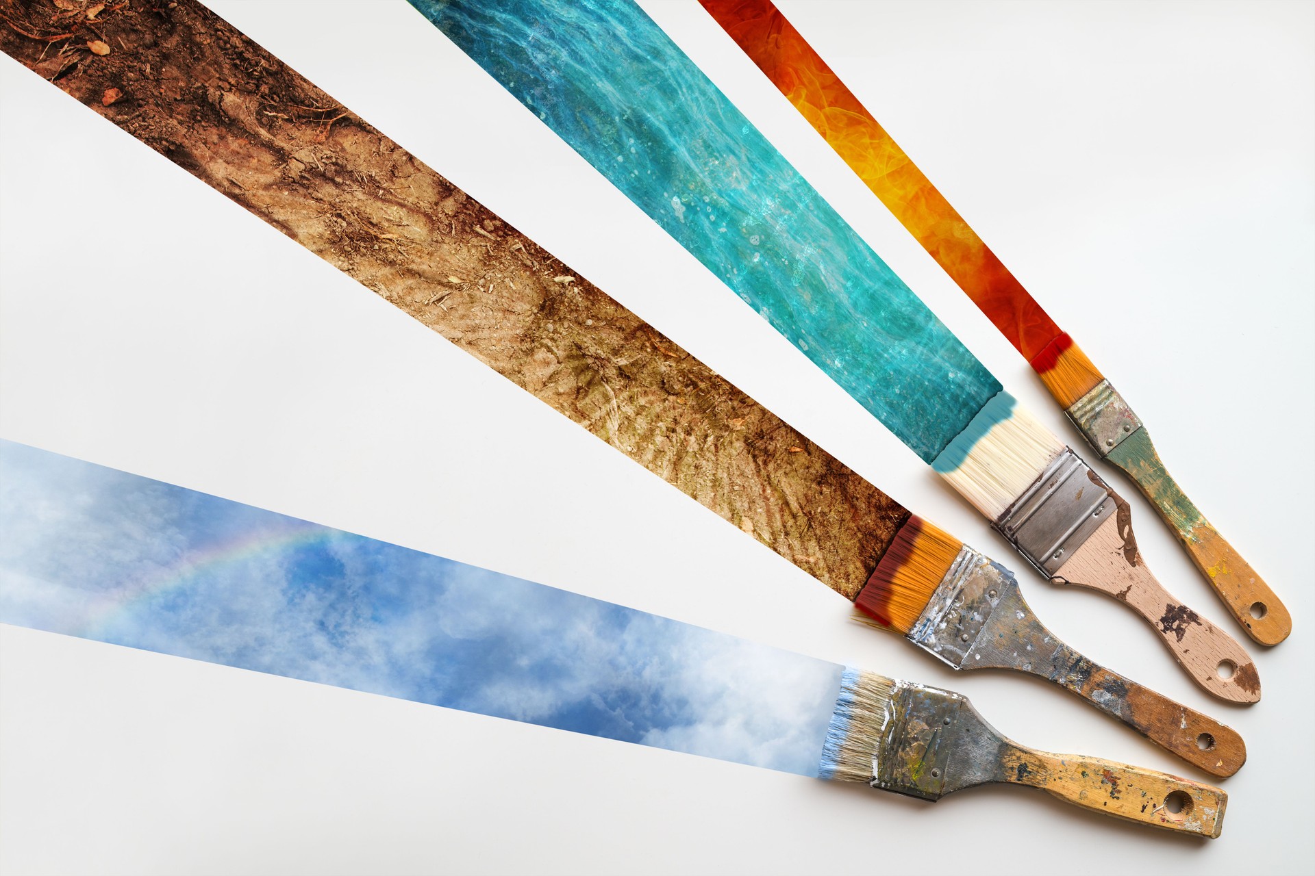 Brushes painting stipes of the four elements of nature, fire, water, earth and air on a white background, ecology concept for environmentally friendly and sustainable business and economy, copy space